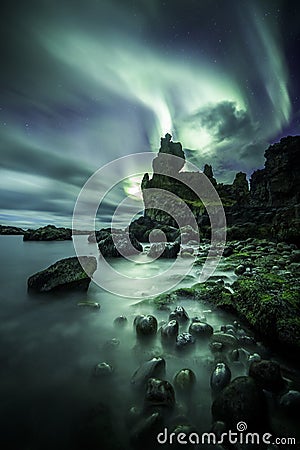 Aurora Borealis Northern Lights above londrangar rock formation Stock Photo