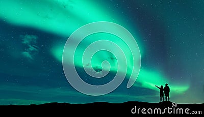 Aurora borealis and silhouette of man and woman Stock Photo