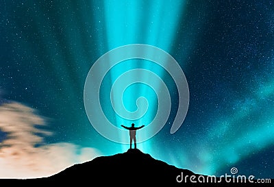 Aurora and silhouette of standing man with raised up arms Stock Photo