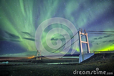 Auroral display over the bridge Iceland. Stock Photo