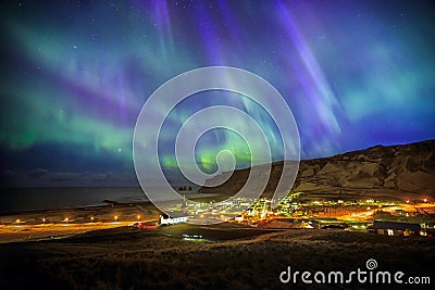 Auroral display over Vik city Stock Photo