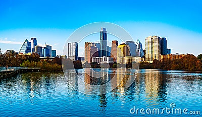 Austin Texas Reflections of a Blue Town Lake and Sunset Skyline at the Pedestrian Bridge on a gorgeous clear sky sunny afternoon Stock Photo