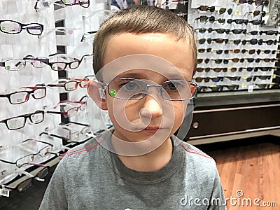 Child trying on new eye glasses Stock Photo