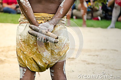 Australian aboriginal people holding Traditional Wood Claves percussion instruments. Stock Photo
