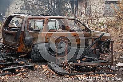 Australian bushfire aftermath: Burnt car and rubble Stock Photo
