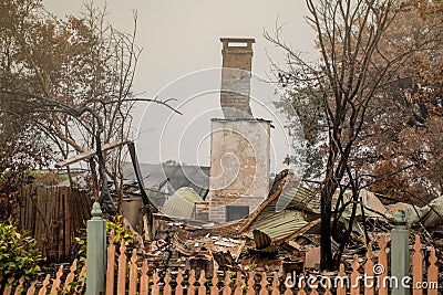 Australian bushfire aftermath: A lonely chimney on burnt building remains Stock Photo