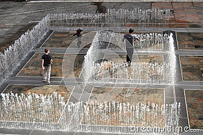 Australian people family playing in fountain at Patio outdoor Editorial Stock Photo