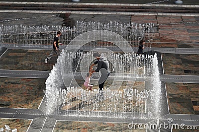 Australian people family playing in fountain at Patio outdoor Editorial Stock Photo