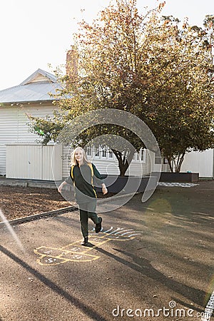 An Australian school girl playing hopscotch Stock Photo