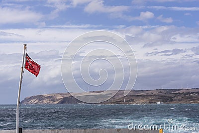 The Australian Red Ensign waving on the ferry that connects Cape Jervis to Penneshaw, Kangaroo Island, Southern Australia Stock Photo