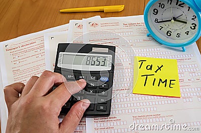 Australian tax forms, hand types on a calculator. Tax concept. Tax time. Editorial Stock Photo