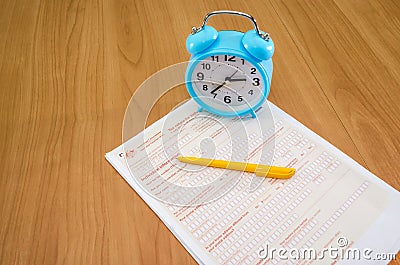 Australian tax forms with a yellow pen and a blue alarm clock on the table. Tax concept. Editorial Stock Photo