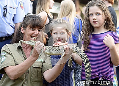 Australian wildlife woman park ranger teaching children about native crocodiles at local fair Editorial Stock Photo