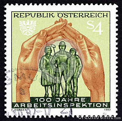 AUSTRIA - CIRCA 1983: A stamp printed in Austria shows hands protecting workers, circa 1983. Editorial Stock Photo