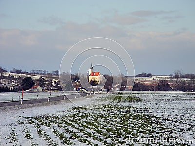 Austria, snow-covered fields and tiny village in winter Stock Photo