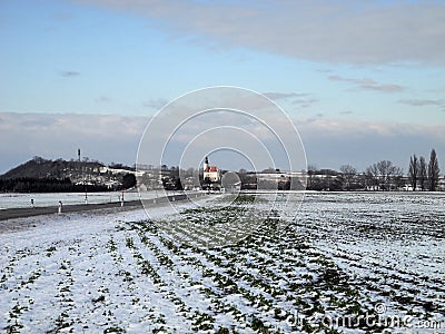 Austria, snow-covered fields and tiny village in winter Stock Photo