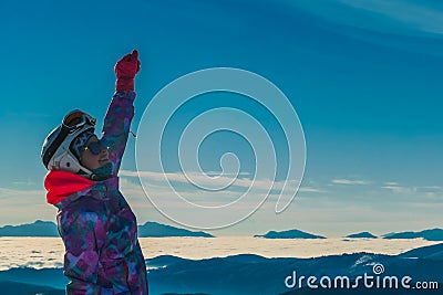 Austria - Snowboarder Girl With a hand rised up Stock Photo