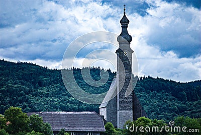 Austrian church standing strong against the incoming storm Stock Photo