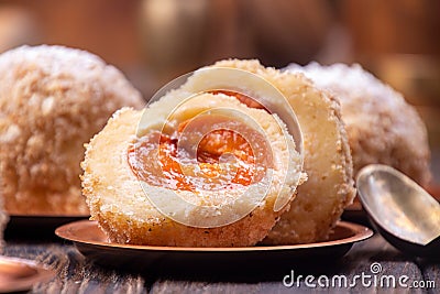 Austrian and czech sweet dessert knedle apricot dumplings on wooden background. Filled cottage cheese dough. close up Stock Photo