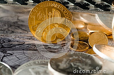 Austrian Gold Coin Philharmonic with Silver Bars & Coins Stock Photo