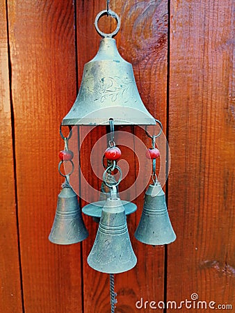 Authentic brass doorbell on a background of yellow-orange wooden planks Stock Photo