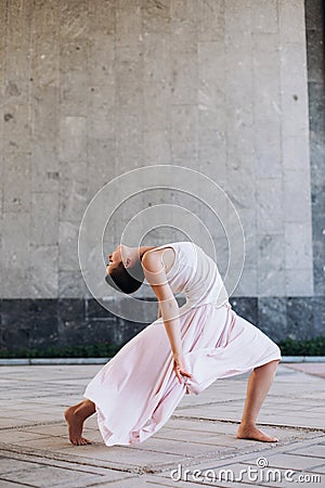 Authentic girl dancing on the street barefoot Stock Photo