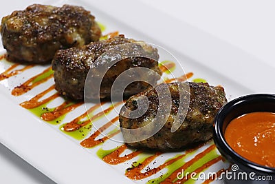 authentic mediterranean arabic cuisine, juicy beef or lamb meat and cheese kebab with spiced red harissa sauce Stock Photo