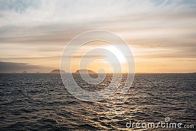 Authentic nord view of sunset ocean and cloudy mountains Stock Photo