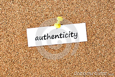 Authenticity. Word written on a piece of paper, cork board background Stock Photo