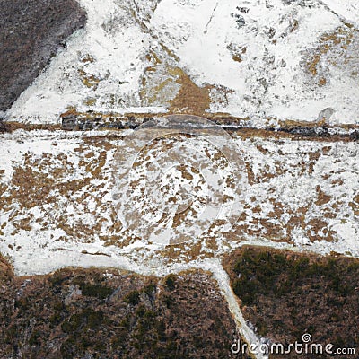 An aerial view on an East European field with partially melted snow, trenches and woods Stock Photo