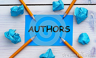 AUTHORS - word on blue paper on a light background with crumpled pieces of paper and pencils Stock Photo