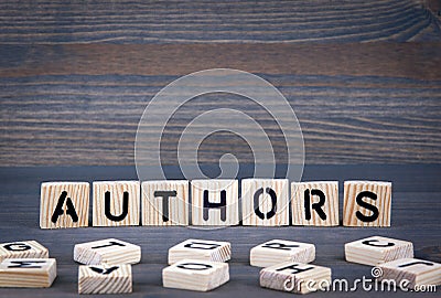 Authors word written on wood block. Dark wood background with texture Stock Photo