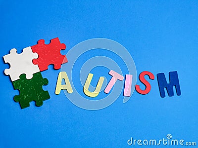 Autism awareness concept with jigsaw puzzles on blue background. Stock Photo