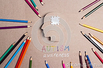 Autism Awareness Day concept with puzzles brain symbol and color pencils. Stock Photo