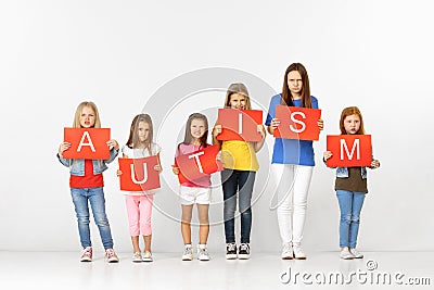 Autism. Group of children with red banners isolated in white Stock Photo