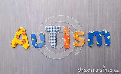 Autism word spelled out in bright colorful patterened letters on brushed metal background Stock Photo