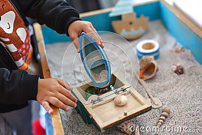 Autistic kid play alone with train toys Stock Photo