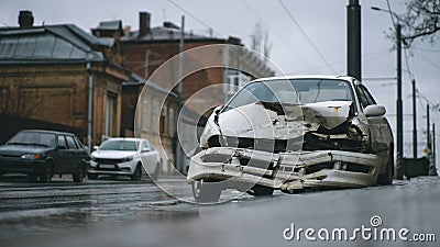 Auto accident on the street. A car damaged after a severe accident stands on a city street. Stock Photo