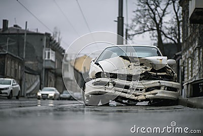 Auto accident on the street. A car damaged after a severe accident stands on a city street Stock Photo