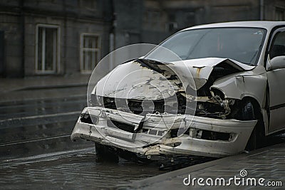 Auto accident on the street. A car damaged after a severe accident stands on a city street. Stock Photo