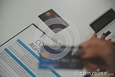 auto business, sale and people concept - close up of customer giving credit card to car dealer in auto show or salon Stock Photo