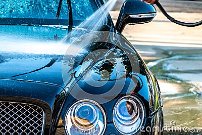 Auto detailer washing luxury high end car Stock Photo