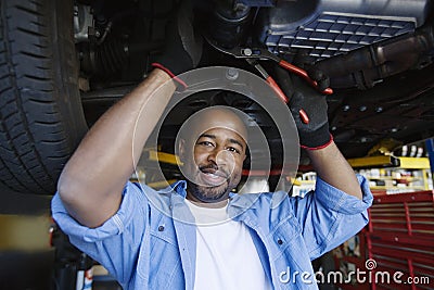 Auto Mechanic Beneath A Car Stock Photo