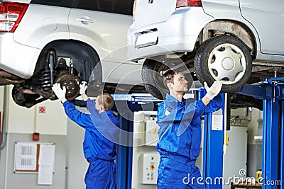 Auto mechanic at car suspension repair work Stock Photo