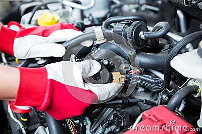 Auto mechanic checking car engine electrical connections Stock Photo
