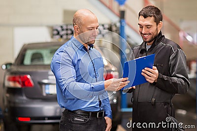 Auto mechanic and customer at car shop Stock Photo