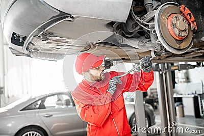 Auto mechanic diagnosing car at the car service Stock Photo