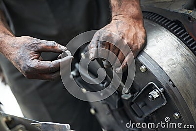 Auto mechanic hands at car repair work Stock Photo