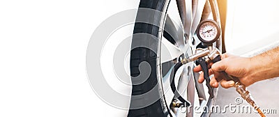 A auto mechanic inflates a tire with an air tire inflating gun,horizontal copy space Stock Photo
