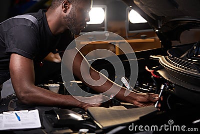 Auto mechanic male use wrench and other tools for fixing a car engine Stock Photo